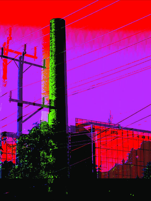 Glitch photo of a smokestack and powerlines against a red-and-purple saturated sky.